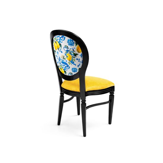 Black Chandelle chair with oval floral back in blue and yellow tones and yellow upholstered seat, elegant vintage-style banquet chair for weddings and formal events
