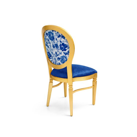 Gold Chandelle chair with oval floral back in blue tones and blue upholstered seat, elegant vintage-style banquet chair for weddings and formal events