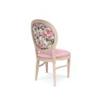 Natural Chandelle chair with oval floral back and blush upholstered seat, elegant vintage-style banquet chair for weddings and formal events