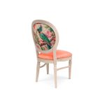 Natural Chandelle chair with oval floral back and coral upholstered seat, elegant vintage-style banquet chair for weddings and formal events