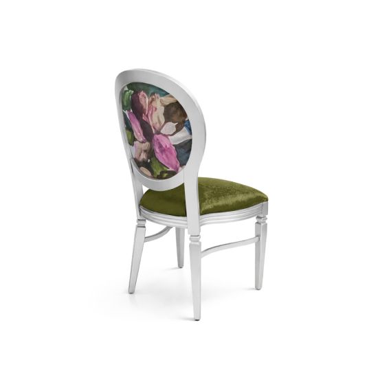 Silver dining chair with green velvet seat and oval backrest featuring abstract floral design for elegant event and wedding seating