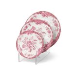Pink and white floral ceramic dinner plates with ornate vintage pattern and decorative border displayed on stand for elegant table settings