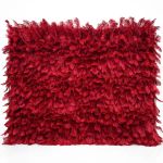 Deep red feather-style plume wall backdrop with layered texture, dramatic photo backdrop panel for luxury weddings and event staging.