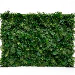 Dense tropical foliage wall backdrop with layered green leaves, botanical photo backdrop panel for events, lounges, and weddings.