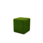 Grass ottoman covered in green artificial turf with cube shape, versatile lounge footrest or seat rental for outdoor events.