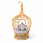 Bohemian single hanging wicker bed with teardrop pod design and cushions, statement lounge rental for boho weddings and events.