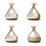 Bohemian wicker bed with teardrop canopy frame and cream cushion, statement lounge bed rental for boho weddings and outdoor events.
