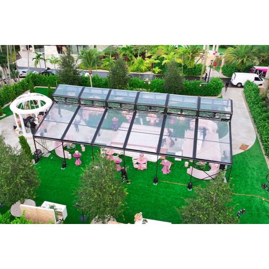 30′x100′ cathedral tent with black frame and clear top for elegant outdoor weddings and upscale events