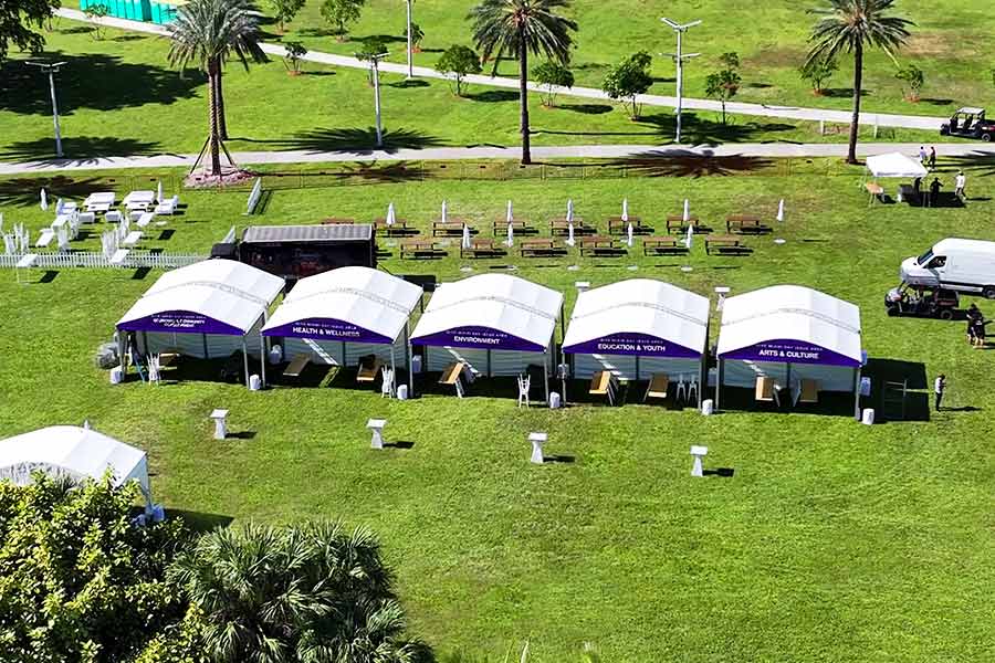 Row of white curved modular tents displaying 