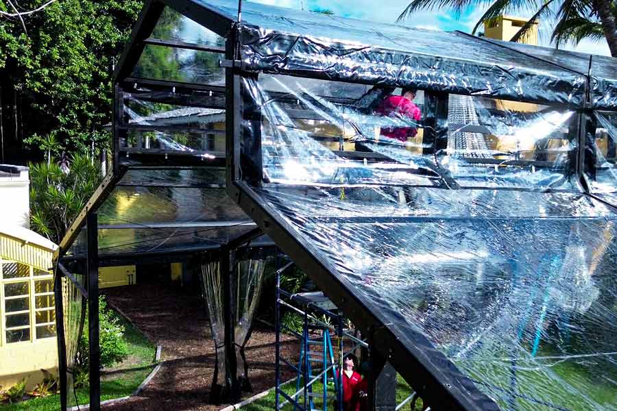 Close up of a clear frame tent with black accents showing the vinyl tent covering.