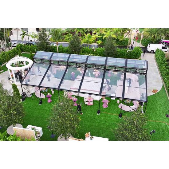 30′x100′ cathedral tent with black frame and clear top for elegant outdoor weddings and upscale events