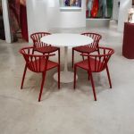 Red Malibu chair with curved slatted back and sleek frame, bold modern seating option for events, patios, and reception dining