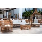 Bohemian single hanging wicker bed with teardrop pod design and cushions, statement lounge rental for boho weddings and events.