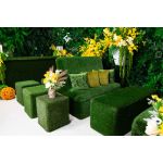 Grass ottoman covered in green artificial turf with cube shape, versatile lounge footrest or seat rental for outdoor events.