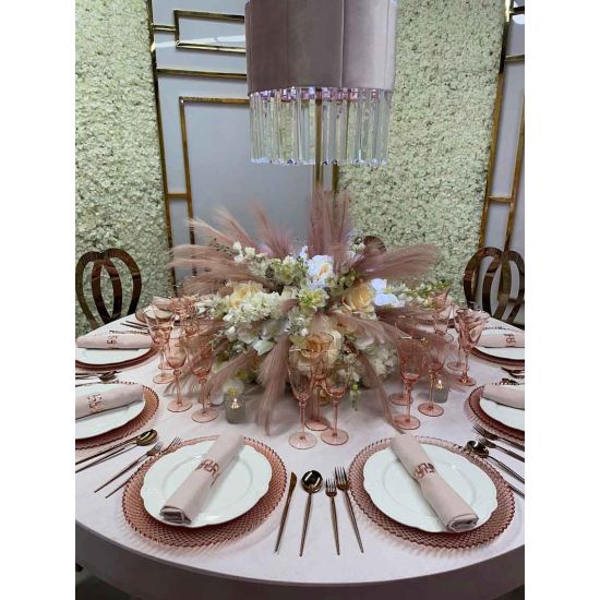 Pink harlequin charger plate with detailed radial geometric texture and glossy glass finish, romantic charger for wedding table settings
