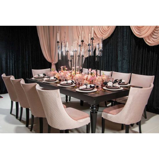 Isabella dining chair with Light Pink upholstered seat and curved high back, black wood legs, sleek modern seating for weddings and events.