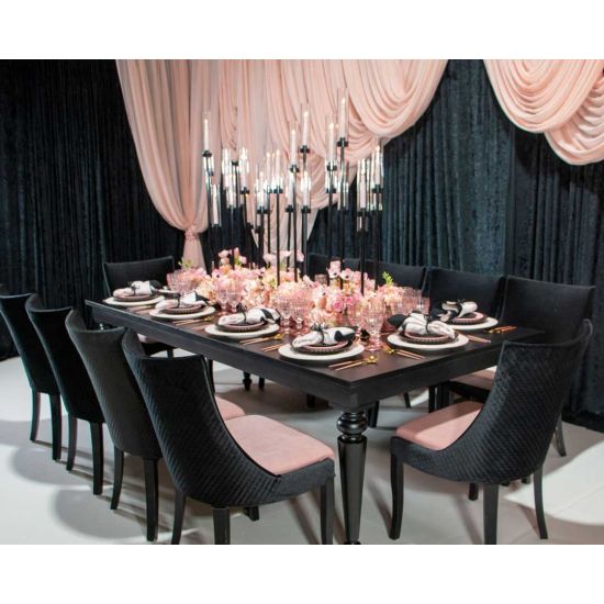 Isabella dining chair with Light Pink upholstered seat and curved high back, black wood legs, sleek modern seating for weddings and events.