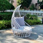 White leaf chair with sculptural open leaf frame and seat cushion, modern accent chair rental for weddings and event lounges.