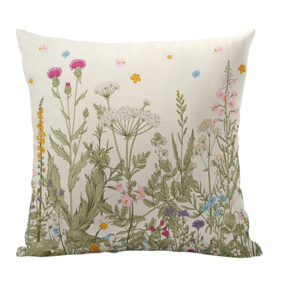 Cream throw pillow with wildflower meadow illustration and green foliage, soft botanical accent cushion for weddings and lounge décor styling.