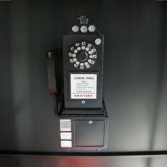Black luxury telephone booth with glass panel doors and red interior flooring, photo booth-style event rental.