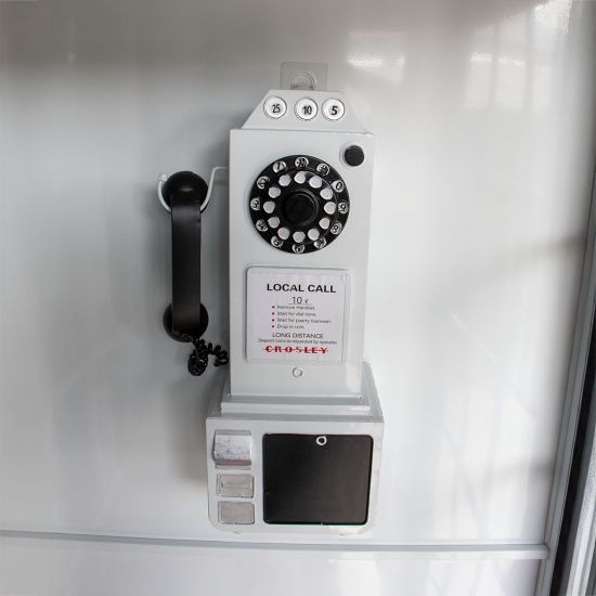 White luxury telephone booth with glass panel doors and red interior flooring, photo booth-style wedding rental.