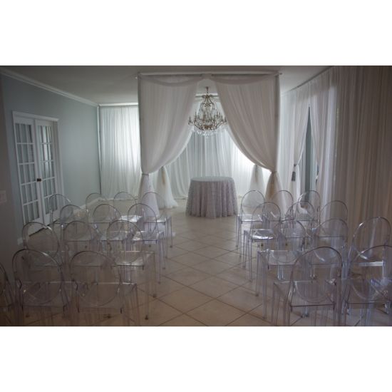“Clear resin armless ghost chair with high oval backrest and transparent sleek frame, modern event guest seating”