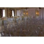 “Clear resin armless ghost chair with high oval backrest and transparent sleek frame, modern event guest seating”