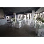 “Clear resin armless ghost chair with high oval backrest and transparent sleek frame, modern event guest seating”