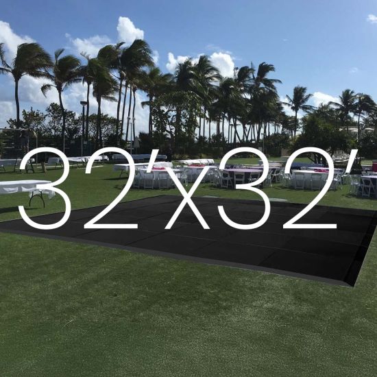 Black outdoor dance floor on lawn with 32x32 size overlay text, modular 4x4 panel dance floor for events up to 300 guests.