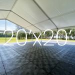 Black Duratrack subfloor under tent with 20x20 size overlay text, modular 4x4 panels for outdoor event flooring base and support.