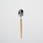 Silver dinner spoon with light wood handle, stylish flatware for catered events, weddings, and polished rustic tablescapes.