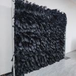 Black feather-style plume wall backdrop with layered texture, dramatic photo backdrop panel for luxury events and stage décor.