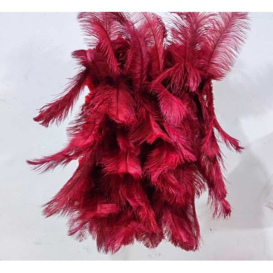 Deep red feather-style plume wall backdrop with layered texture, dramatic photo backdrop panel for luxury weddings and event staging.