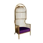 Gold dome cage armchair with vertical gold bars and eggplant velvet seat cushion, modern luxury lounge chair for weddings and events.