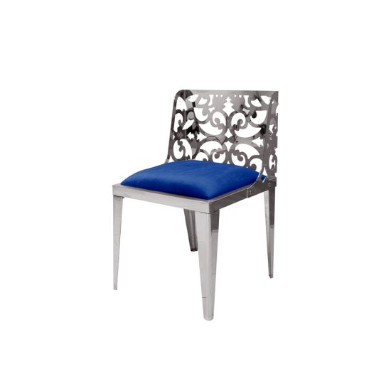 Silver reflection chair with ornate laser-cut scroll backrest and royal blue cushioned seat, sleek modern design for upscale event dining and seating.
