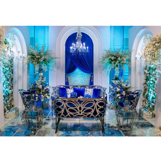 Reflection butterfly loveseat with silver metal cutout backrest and Royal Blue velvet seat cushion, elegant modern seating for upscale events.