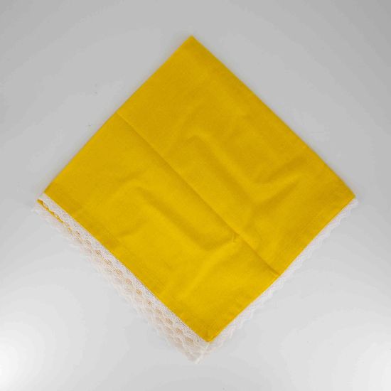 Yellow table napkin with white lace trim detail, neatly folded on a white plate for bright spring weddings and event table settings