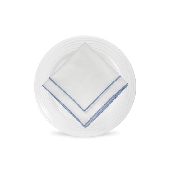 White Monarch napkin with blue border trim detail, folded in a triangle on a white plate for coastal weddings and elegant event settings