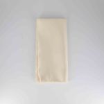 Ivory polyester napkin with soft solid fabric finish, folded on a white plate for classic weddings and elegant event table settings