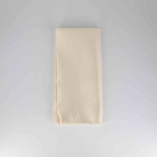 Ivory polyester napkin with soft solid fabric finish, folded on a white plate for classic weddings and elegant event table settings