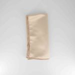 Camel satinesa napkin with smooth satin-like fabric finish in warm neutral tone, folded on a white plate for elegant event table settings