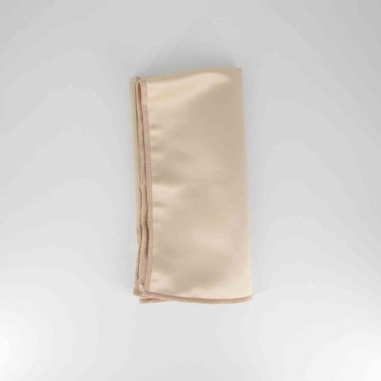 Camel satinesa napkin with smooth satin-like fabric finish in warm neutral tone, folded on a white plate for elegant event table settings