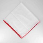 White napkin with red stitched trim border, folded in a triangle on a white plate for festive weddings and classic event table settings