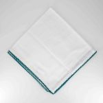 White napkin with teal green stitched trim border, folded in a triangle on a white plate for modern weddings and stylish event tables