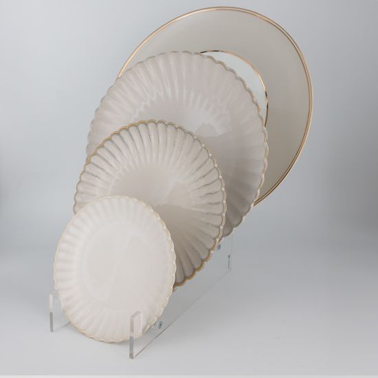 Bone-colored petal-rim salad plate with scalloped edge and sunburst ridged design, medium round plate on a white background
