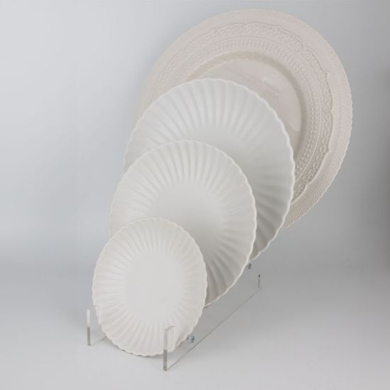White petal-rim salad plate with scalloped edge and sunburst ridged design, medium round plate on a white background