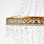Gold acrylic crystal chandelier set with tiered bead strands, elegant hanging décor lighting for weddings, lounges, and event staging.