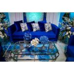 Royal Blue velvet Reflection Giraffe sofa with gold abstract slat metal base and matching pillows, luxury seating for upscale weddings and events.