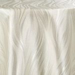 Ivory Charisma metallic sheen round event tablecloth draped over banquet table for weddings, receptions, and upscale party décor