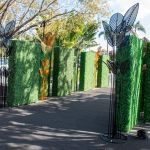 Black metal palm leaf floor sculpture with multiple leaves, modern tropical event décor accent.